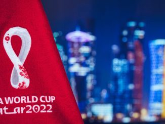 Bandera de la Copa Mundial de la FIFA Qatar 2022, horizonte nocturno de Doha en segundo plano